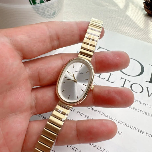 Reloj de pulsera moderno para mujer, diseño ovalado de cuarzo con correa metálica de bambú